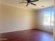 Bright, minimalist bedroom with hardwood floors and a large window offering serene views at 1390 E Jasper Dr, Gilbert, AZ 85296