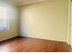 Bright, spacious bedroom featuring a window and wood-look flooring at 1390 E Jasper Dr, Gilbert, AZ 85296