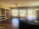 Open-concept living space filled with natural light, featuring a built-in shelving unit and sliding glass doors at 1390 E Jasper Dr, Gilbert, AZ 85296