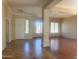 Spacious living room featuring wood and tile floors, crown molding, and lots of natural light at 1390 E Jasper Dr, Gilbert, AZ 85296