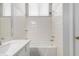 Tiled bathroom showcasing a tub and shower combination, along with a modern sink and vanity area at 1501 E Sunland Ave, Phoenix, AZ 85040