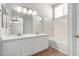 Bathroom features a double sink vanity, a large mirror, and a tiled bathtub/shower combination at 1501 E Sunland Ave, Phoenix, AZ 85040