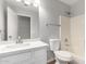 Clean bathroom features a sink with white cabinets, tile flooring and bath tub with shower at 1501 E Sunland Ave, Phoenix, AZ 85040