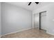 Bedroom with neutral walls includes tile floor, closet with mirrored doors and ceiling fan at 1501 E Sunland Ave, Phoenix, AZ 85040