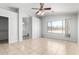Bright bedroom boasts tile floors, a ceiling fan, and en suite bathroom access, creating a private retreat at 1501 E Sunland Ave, Phoenix, AZ 85040