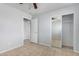 Neutral bedroom features tile floors, closet with mirror doors, and overhead lighting at 1501 E Sunland Ave, Phoenix, AZ 85040