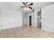 Bedroom with tiled floors and a ceiling fan, offering comfort and convenient access to adjoining rooms at 1501 E Sunland Ave, Phoenix, AZ 85040