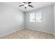 Cozy bedroom features a ceiling fan, a window, and neutral tones, creating a relaxing space at 1501 E Sunland Ave, Phoenix, AZ 85040