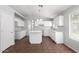 Modern kitchen with white cabinets, granite countertops, an island, and tile flooring at 1501 E Sunland Ave, Phoenix, AZ 85040