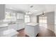 Modern kitchen with white cabinets, granite countertops, an island, and tile flooring at 1501 E Sunland Ave, Phoenix, AZ 85040