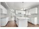 Modern kitchen with white cabinets, granite countertops, an island, and tile flooring at 1501 E Sunland Ave, Phoenix, AZ 85040