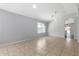 Spacious living room featuring neutral paint, tile floors, and view to another room at 1501 E Sunland Ave, Phoenix, AZ 85040