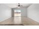 Bright living area features neutral paint, tile floors, and sliding glass door to backyard at 1501 E Sunland Ave, Phoenix, AZ 85040
