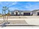 Inviting single-story home featuring desert landscaping, a two-car garage, and a welcoming entrance at 15349 W Cottontail Ln, Surprise, AZ 85387