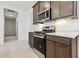 Modern kitchen showcasing stainless steel appliances, dark wood cabinets, and elegant countertops for a sleek design at 15349 W Cottontail Ln, Surprise, AZ 85387