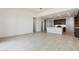 Open-concept living room and kitchen with modern tile flooring and plenty of natural light at 15349 W Cottontail Ln, Surprise, AZ 85387