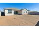 New construction backyard has block fencing, covered patio, and plenty of space for entertaining at 15357 W Cottontail Ln, Surprise, AZ 85387