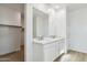 Bright bathroom vanity includes double sinks, large mirror, and a walk-in closet at 15357 W Cottontail Ln, Surprise, AZ 85387
