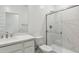 Bathroom features white cabinets, marble countertop, toilet, and frameless glass shower doors at 15357 W Cottontail Ln, Surprise, AZ 85387