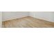 A bright bedroom featuring wood-look floors and white walls at 15357 W Cottontail Ln, Surprise, AZ 85387