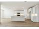 Well-lit kitchen features white cabinets, stainless steel appliances, and a center island at 15357 W Cottontail Ln, Surprise, AZ 85387