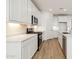 Modern kitchen featuring stainless appliances, white cabinets and counters, with a gas range at 15357 W Cottontail Ln, Surprise, AZ 85387