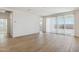 Spacious living room features wood-look tile flooring and large sliding glass doors at 15357 W Cottontail Ln, Surprise, AZ 85387