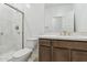 Modern bathroom featuring a walk-in shower, wooden vanity, and brushed gold hardware at 15365 W Cottontail Ln, Surprise, AZ 85387