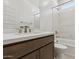 Modern bathroom featuring vanity with quartz countertop and bathtub with marble backsplash at 15365 W Cottontail Ln, Surprise, AZ 85387