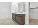 Bathroom features a double sink vanity, modern mirrors, and recessed lighting at 15365 W Cottontail Ln, Surprise, AZ 85387