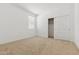 Bedroom with carpet flooring and an open closet with white trim at 15365 W Cottontail Ln, Surprise, AZ 85387
