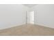 Bedroom with carpet flooring and white trim leading to the hallway at 15365 W Cottontail Ln, Surprise, AZ 85387