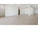 Spacious open floor plan featuring tile flooring, white walls, and modern lighting at 15365 W Cottontail Ln, Surprise, AZ 85387
