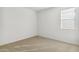 Carpeted bedroom with a window and white walls at 15402 W Cottontail Ln, Surprise, AZ 85387