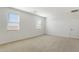 Bright, spacious bedroom features neutral carpet, two windows, and white walls at 15402 W Cottontail Ln, Surprise, AZ 85387