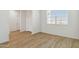 Bright living room with wood floors and a window at 15402 W Cottontail Ln, Surprise, AZ 85387