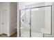 Elegant walk-in shower with white marble walls and built-in bench seating at 15402 W Cottontail Ln, Surprise, AZ 85387