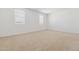 Bedroom with carpet flooring, bright neutral walls, and large windows providing natural light at 15429 W Cottontail Ln, Surprise, AZ 85387