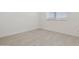 Cozy bedroom with a window for natural light and neutral tile flooring at 15429 W Cottontail Ln, Surprise, AZ 85387