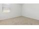 Bedroom with carpet flooring, bright neutral walls, and window providing natural light at 15429 W Cottontail Ln, Surprise, AZ 85387
