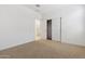 Bedroom with carpet flooring and closet with sliding doors. The ensuite bathroom can be seen at 15429 W Cottontail Ln, Surprise, AZ 85387