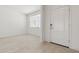 Bright entryway with neutral walls, tiled floors, and a white front door at 15429 W Cottontail Ln, Surprise, AZ 85387
