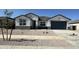 Charming single-Gathering home featuring a gray garage door, modern stucco, and low-maintenance desert landscaping at 15429 W Cottontail Ln, Surprise, AZ 85387