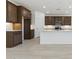 Spacious kitchen featuring quartz countertops, wood cabinets, and stainless steel appliances at 15429 W Cottontail Ln, Surprise, AZ 85387