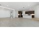 Bright and airy living room with modern tile flooring and an open-concept design at 15429 W Cottontail Ln, Surprise, AZ 85387