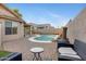 Picturesque backyard boasting a sparkling pool, lush landscaping, and stylish patio furniture for relaxation and entertaining at 1673 S 171St Dr, Goodyear, AZ 85338