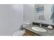 Bathroom featuring a modern sink with granite counters, alongside a white toilet and soft, neutral walls at 1673 S 171St Dr, Goodyear, AZ 85338