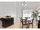 Dining area with a round table, accompanied by dark wood chairs and an elegant chandelier above at 1673 S 171St Dr, Goodyear, AZ 85338