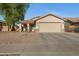 Charming single-story home featuring low maintenance desert landscaping and a neutral color palette at 1673 S 171St Dr, Goodyear, AZ 85338
