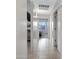 Hallway leading to bedrooms with tile floors and soft, neutral walls, offering a bright and airy feel at 1673 S 171St Dr, Goodyear, AZ 85338